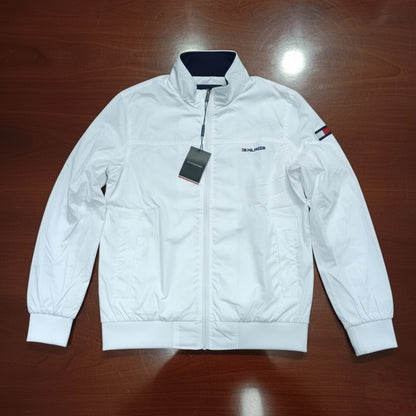 White jacket with a brand tag on a wooden surface