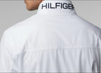 White shirt with 'Tommy Hilfiger' logo on the collar against a gray background