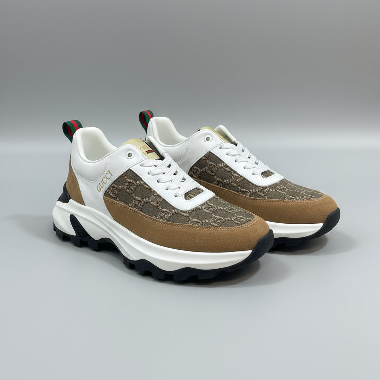 Pair of brown and white sneakers with a pattern on a green surface.