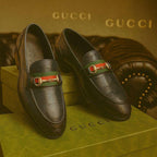Gucci loafers on a Gucci branded box with a gold background