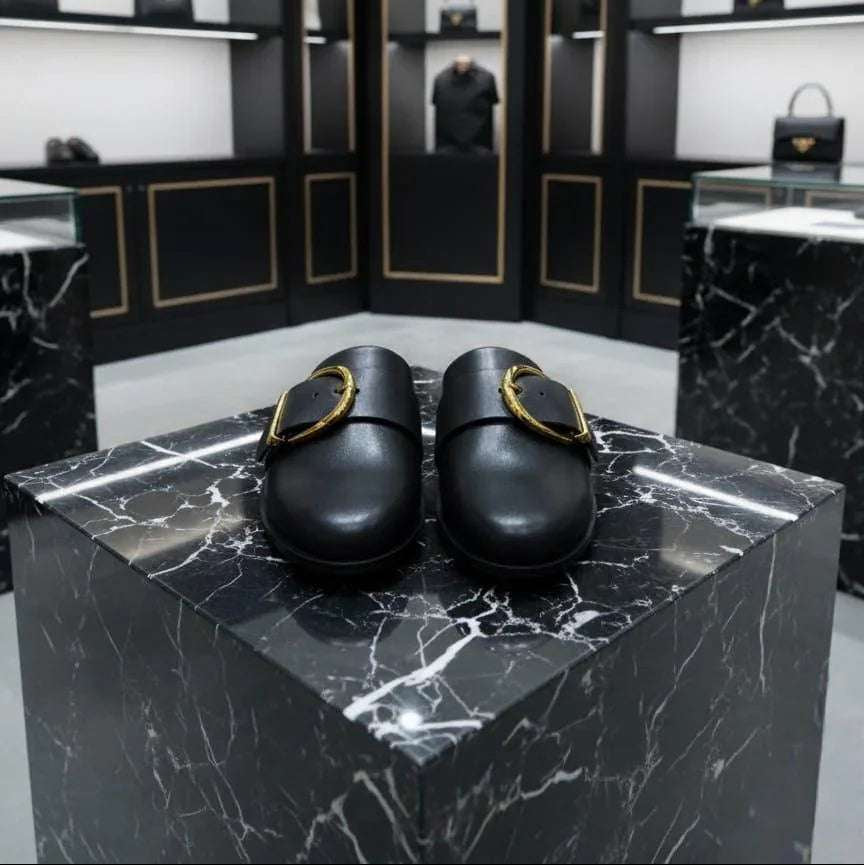 Black shoes on a marble platform with a high-end store interior in the background.