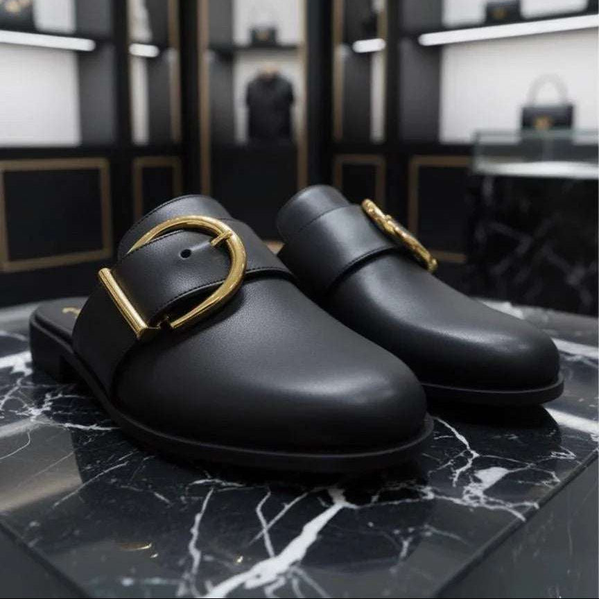 Black shoes with gold buckles on a marble surface, with 'UNIVERSES' branding above.