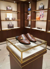 Brown shoes on a glass display case with a store interior background