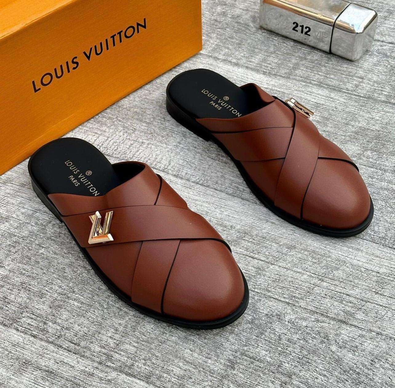 Brown Louis Vuitton shoes with a gold logo on a gray surface, next to an orange box. Main image