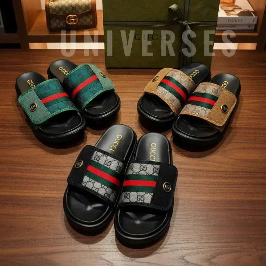 Pair of Gucci slides on a wooden surface with a box and other items in the background. Main image