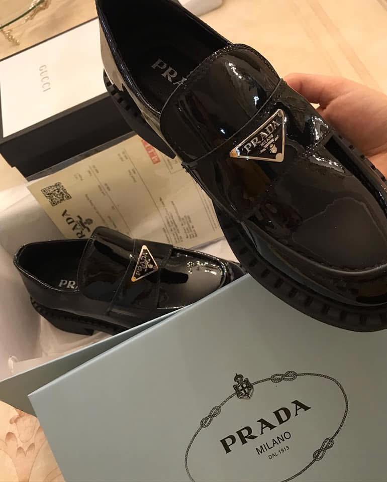 Black Prada shoes with logo on a white box