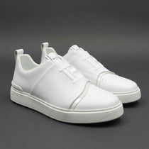 White sneakers on a dark gray background