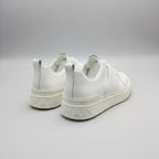 White sneakers with brand logo on a gray background