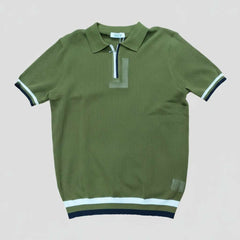 Green polo shirt with white and black trim on a light gray background