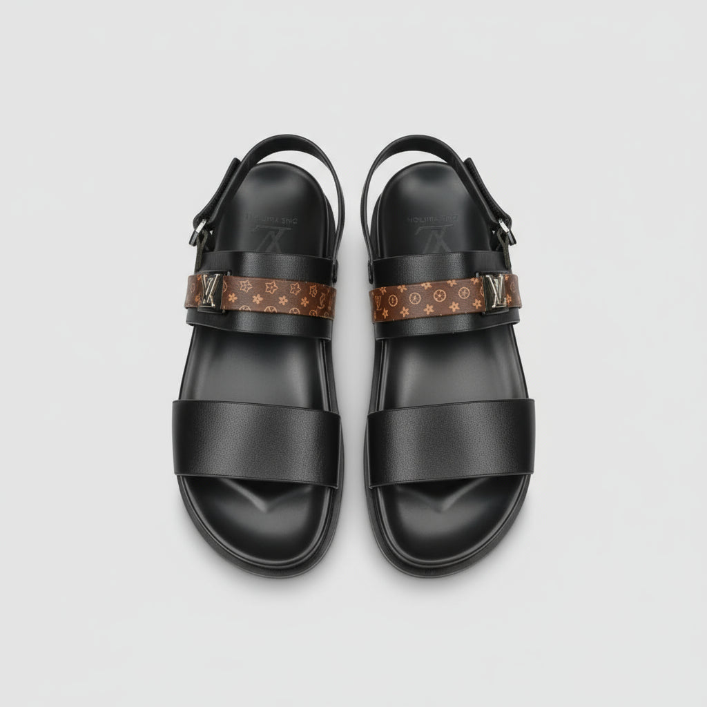 Black sandals with patterned straps on a wooden surface