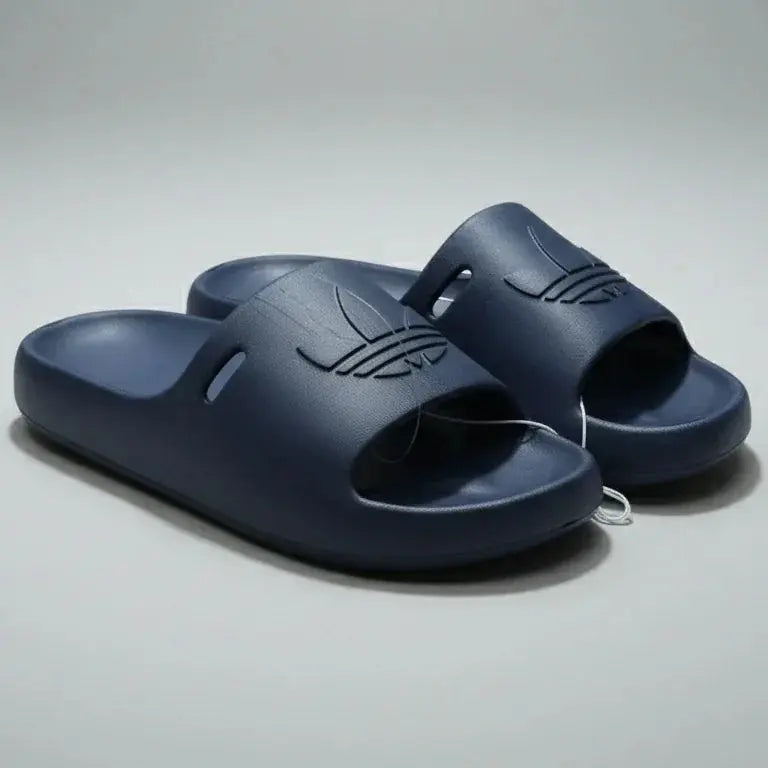 Pair of navy blue slides on a gray background