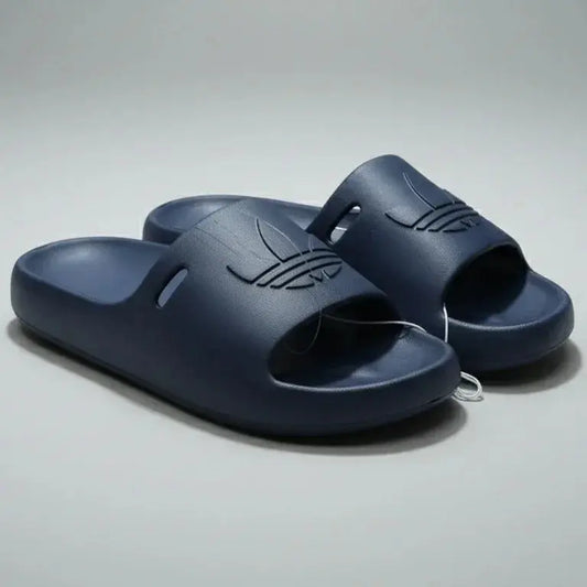 Pair of navy blue slides on a gray background
