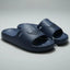 Pair of navy blue slides on a gray background