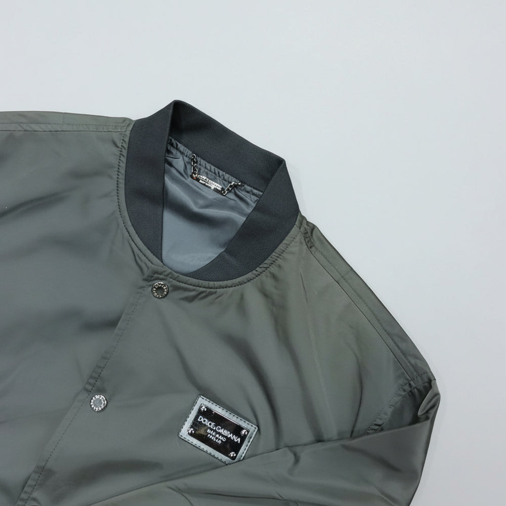 Gray jacket with a brand label on a light gray background