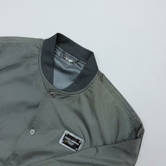 Gray jacket with a brand label on a light gray background