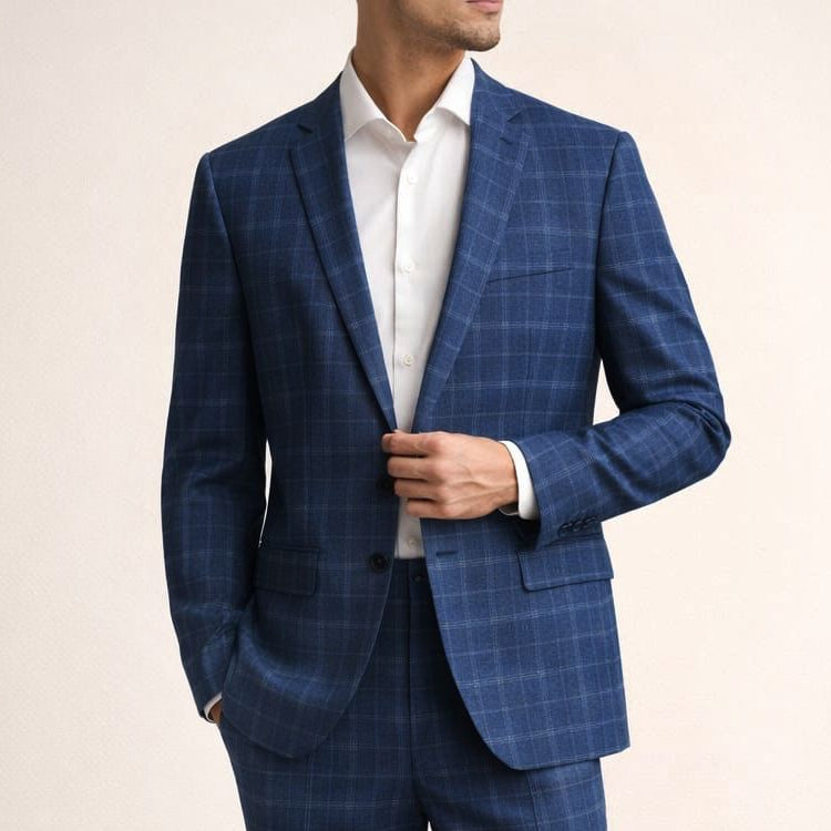 Man wearing a blue checkered suit with a white shirt on a beige background