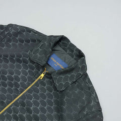 Green patterned jacket with a Louis Vuitton tag on a light gray background