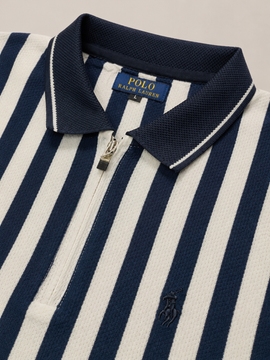 Close-up of a Polo Ralph Lauren zip-front polo shirt with navy and off-white vertical stripes, a navy collar with white piping, and a small navy embroidered pony logo on the chest.